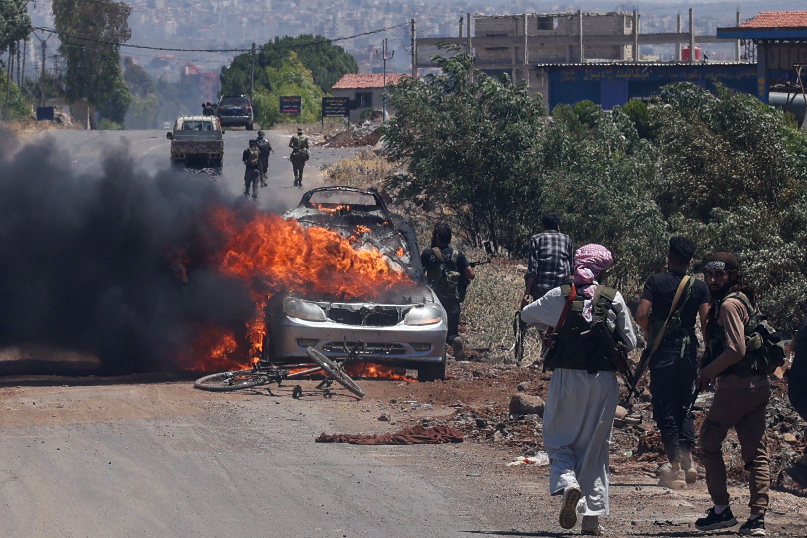 مقاتلون من البدو والقبائل ينتشرون عند المدخل الغربي لمدينة السويداء جنوب سوريا، في 18 تموز/ يوليو 2025. (تصوير: بكر القاسم / وكالة الصحافة الفرنسية)